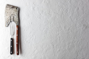 Old rustic axe for meat on a wooden board on grunge background. Food photography
