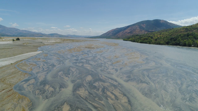 Parched river in mountain province Luzon, Philippines. Aerial view Drought in mountain valley, dry and shallow Bucao river.
