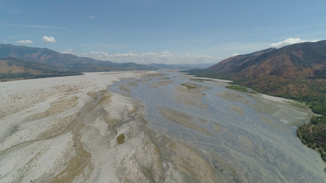 Parched river in mountain province Luzon, Philippines. Aerial view Drought in mountain valley, dry and shallow Bucao river.
