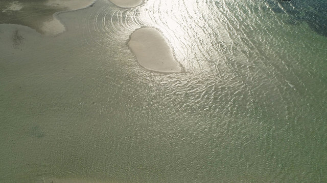 Tropical island with white sandy beach. Aerial view of Tondol White Sand Beach with colorful reef. Seascape, ocean and beautiful beach. Philippines, Anda, Pangasinan. Travel concept.