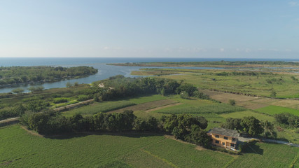 Aerial view of farmland, rice terraces by the sea. Philippines, Luzon. Tropical landscape in Asia.