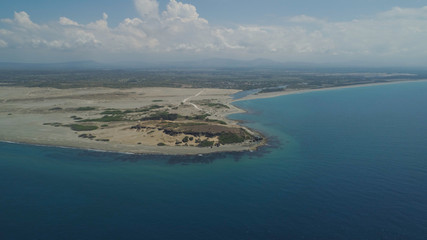 Fototapeta na wymiar Aerial view of seashore with beaches, lagoons and coral reefs. Philippines, Luzon, Ilocos Norte. Coast ocean with turquoise water. Tropical landscape in Asia.