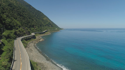 Aerial view of Patapat viaduct in the coast of Pagudpud, Ilocos Norte. Highway with bridge by coast sea near the mountains. Philippines, Luzon. Highway along the coast.