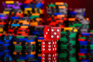 casino concept dice on background of a defocused multicolor set of chips