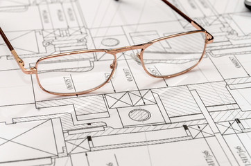 Engineer's drawing with spectacles, close up .