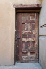 Wooden aged decorated door and stone wall, Medieval Cairo, Egypt