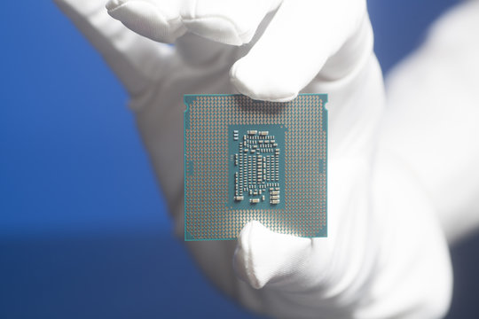 Hand In White Glove Holding A CPU Computer Processor Microchip