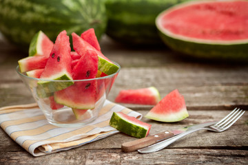 Watermelon slices in bowl with cutlery