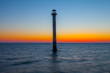 Skew lighthouse in the Baltic Sea. Late sunset time. Kiipsaare, Harilaid, Saaremaa, Estonia, Europe.