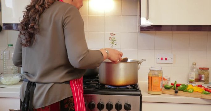 Woman Making Curry at Home