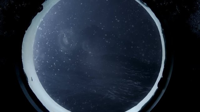 Island Through a Ship Window in the Ocean with Waves and Storm