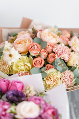 two bouquet of beautiful flowers on gray table. Floristry concept. Spring colors. the work of the florist at a flower shop. Vertical photo