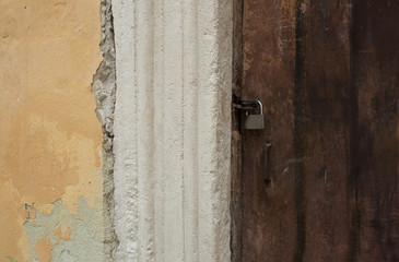 Aged wooden door with a metal lock