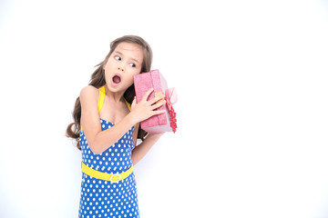 Obraz premium Young girl got suprise gift. Young cute white girl holding a red gift present box, looking funny and surprise. Isolated in white. Birthday girl and family concept.