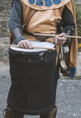 Man plays drum wearing medieval costume
