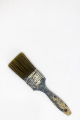 A very used paintbrush on an isolated white background with room for text and other objects 