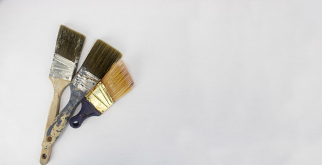 Three used paintbrushes on an isolated white background with room for text and other objects