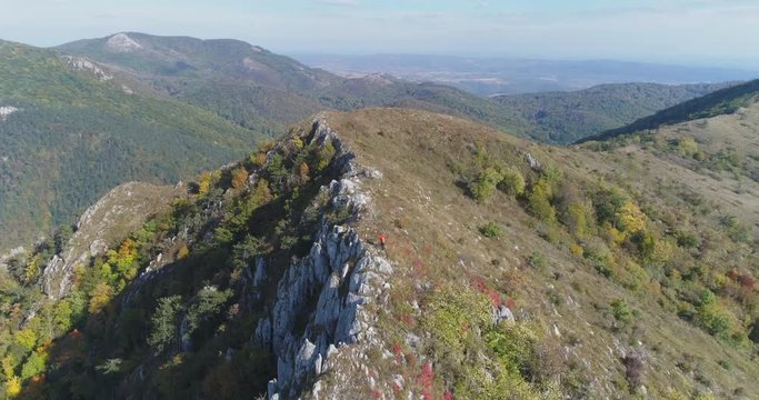 Aerial view of man hiking on the edge of mountain - Transylvania