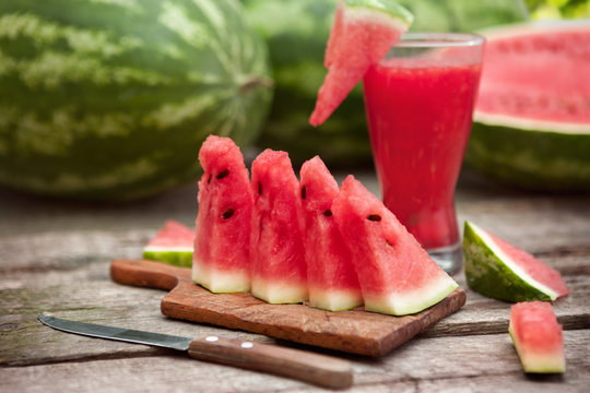 Chopping board with watermelon,juice and cutlery