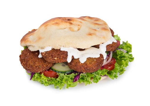 falafel with fresh vegetables in pita bread on white.