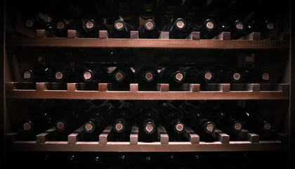 Tuinposter bottles of wine lie on wooden shelves © salahoff