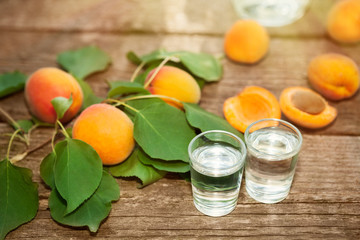 Apricot brandy and fresh apricots on table