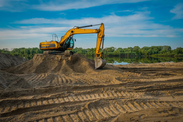 excavator is standing on the sand