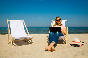 Woman with laptop on beach