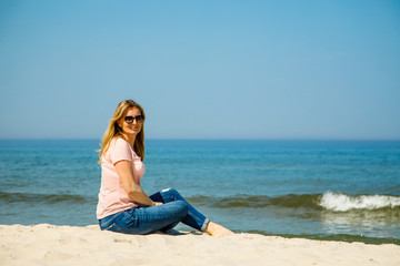 Fototapeta na wymiar Woman relaxing on the beach