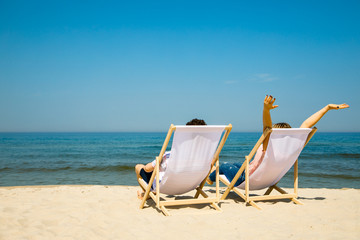 Woman and man relaxing on beach