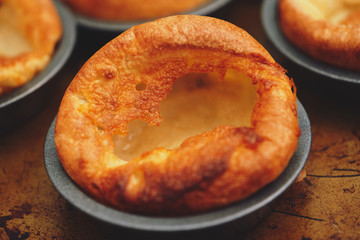 Freshly cooked Yorkshire Puddings for a Sunday roast dinner. British, English cuisine.