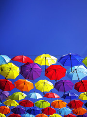 colored umbrellas weighing on the sky background