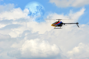 Fototapeta na wymiar Homemade radio control helicopter on blue sky.