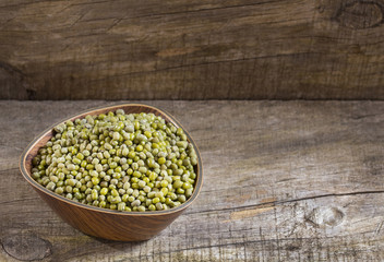 Raw mung beans. Wood background - Vigna radiata