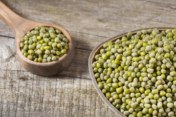 Raw mung beans. Wood background - Vigna radiata