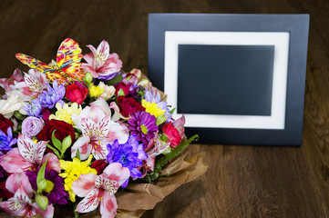beautiful bouquet with different colors and photo frame, colorful bouquet of different fresh flowers