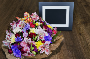 beautiful bouquet with different colors and photo frame, colorful bouquet of different fresh flowers