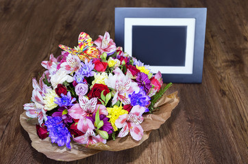 beautiful bouquet with different colors and photo frame, colorful bouquet of different fresh flowers