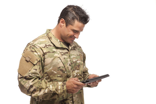 Happy army soldier reading digital tablet