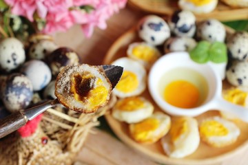 Grilled eggs with sauce on wood background