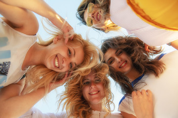 summer, holidays, vacation, happy people concept - group of teenagers looking down