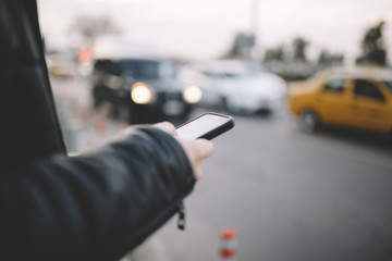 Man Using Smart Phone At City Street