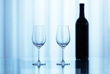 Two wine glasses and a bottle of wine. 