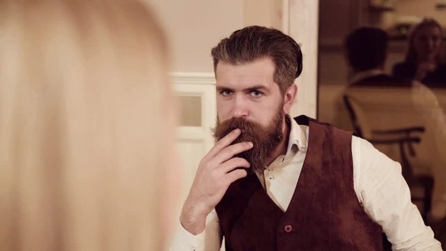 Couple in love. Handsome man flirting with cute woman in restaurant. Bearded man flirting with young sexy blonde
