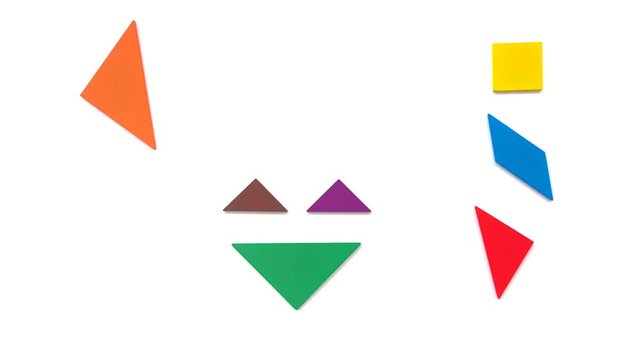 tangram shaped like a clown and a solid square piece on white