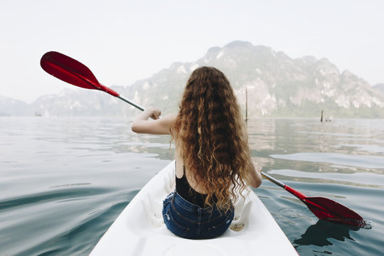 Woman paddling a canoe through a national park