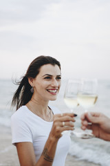 Couple enjoying a glass of wine by the beach