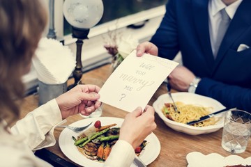 Man proposing girlfriend with card