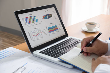 Business man working at office with laptop and documents on his desk