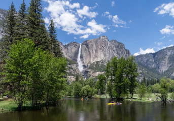 People Tubing Down Merced River in Yosemite with Lower Falls in Background
